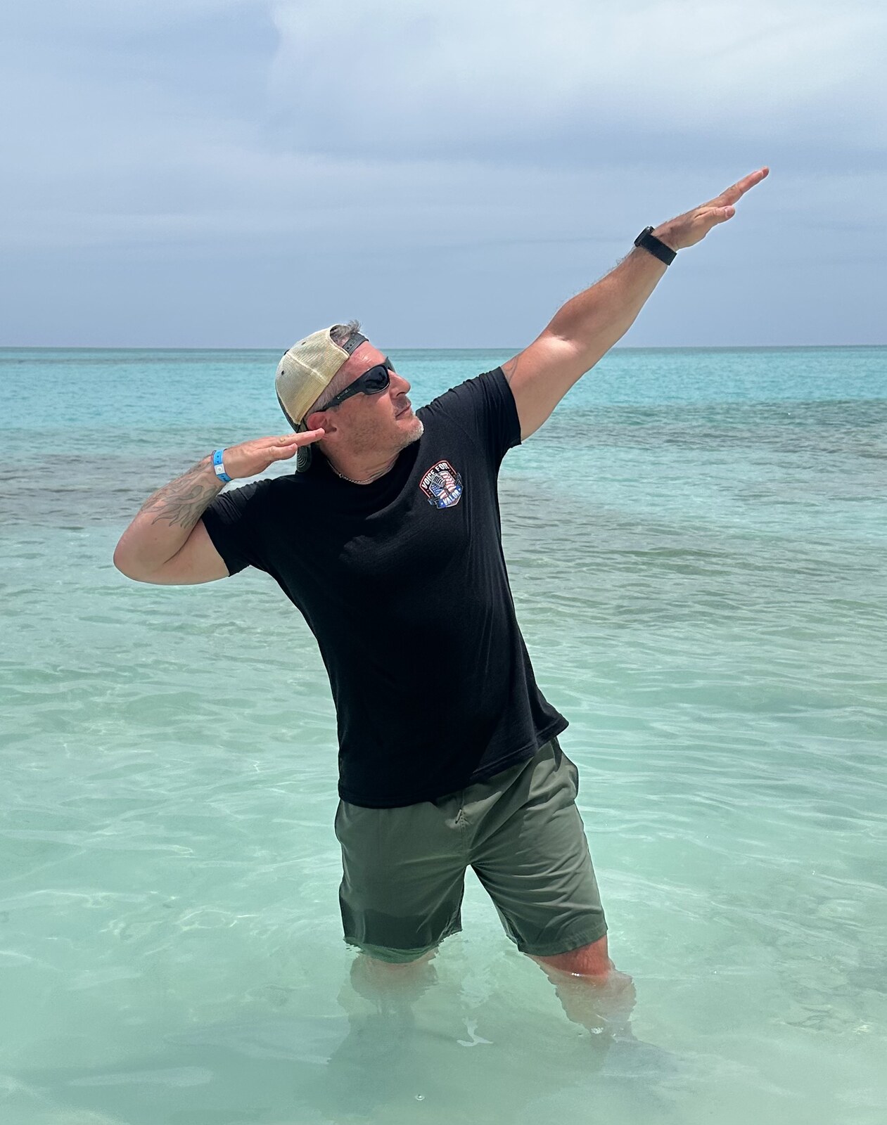 Chief Master Sergeant James Brown wearing a Voice for Valor shirt in clear ocean water