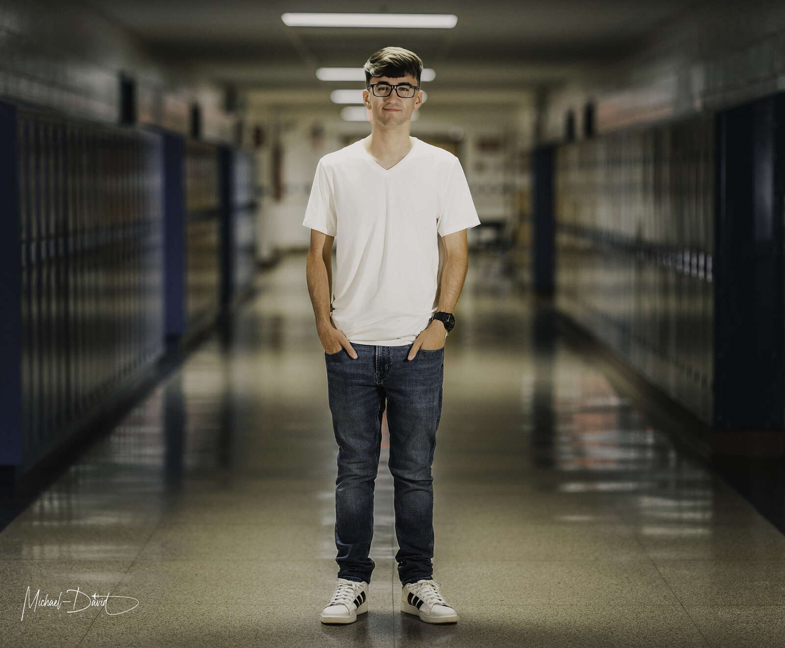 Zach in the hallway, the whole length of the school behind him