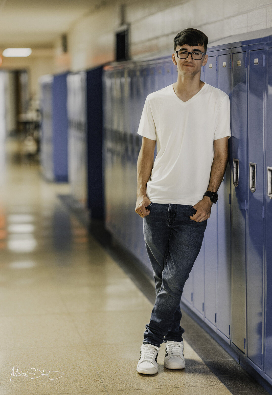 Zach smiling against the lockers