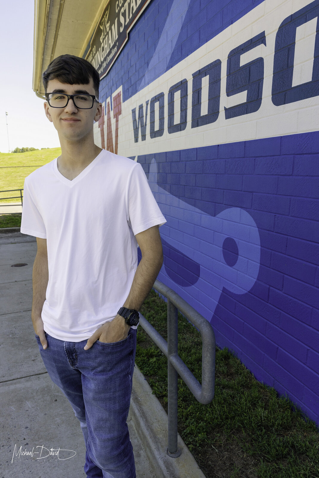 Zach standing by the Woodson stadium wall