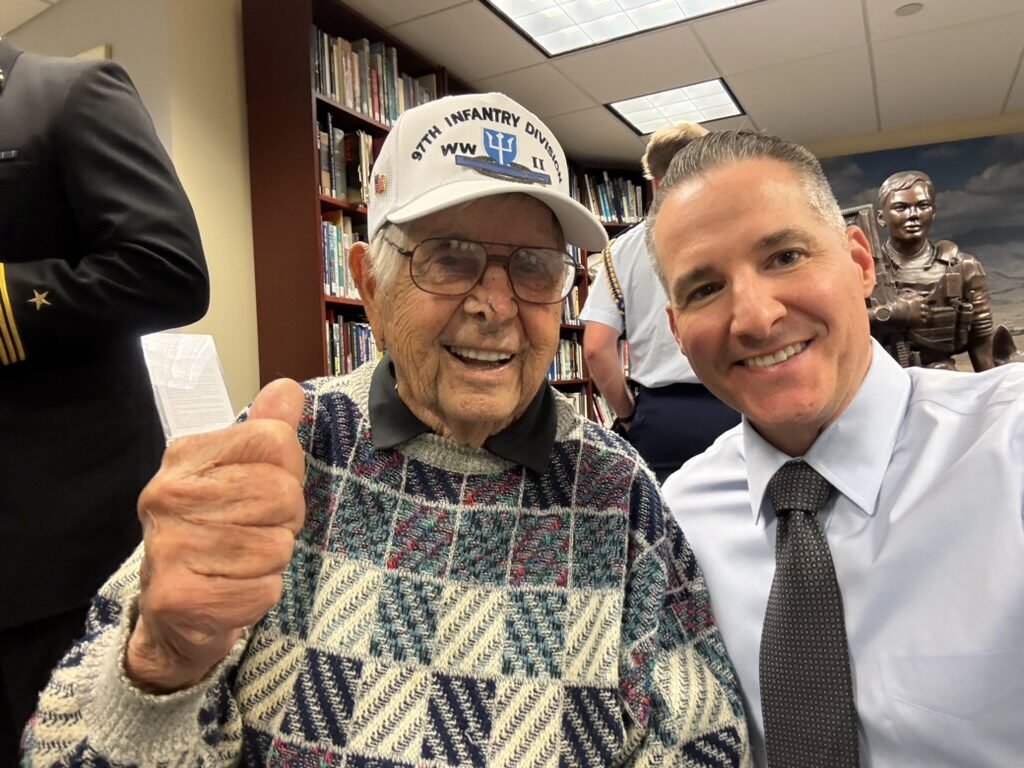 Voice for Valor host Michael Komorous with a World War II veteran of the 9th Infantry Division at the American Veterans Center.