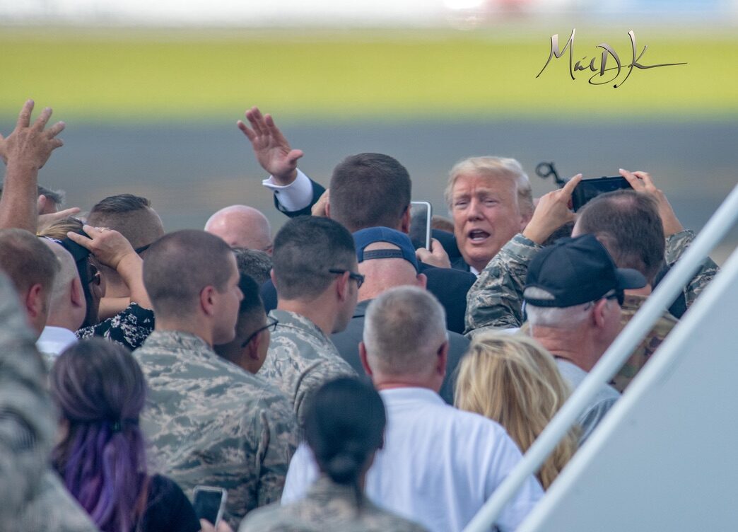President Donald Trump greets Air National Guard members and supporters on the flight line in Charlotte.