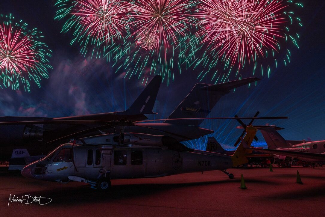 Fireworks burst over the static aircraft display during the Sun 'n Fun Aerospace Expo night show.